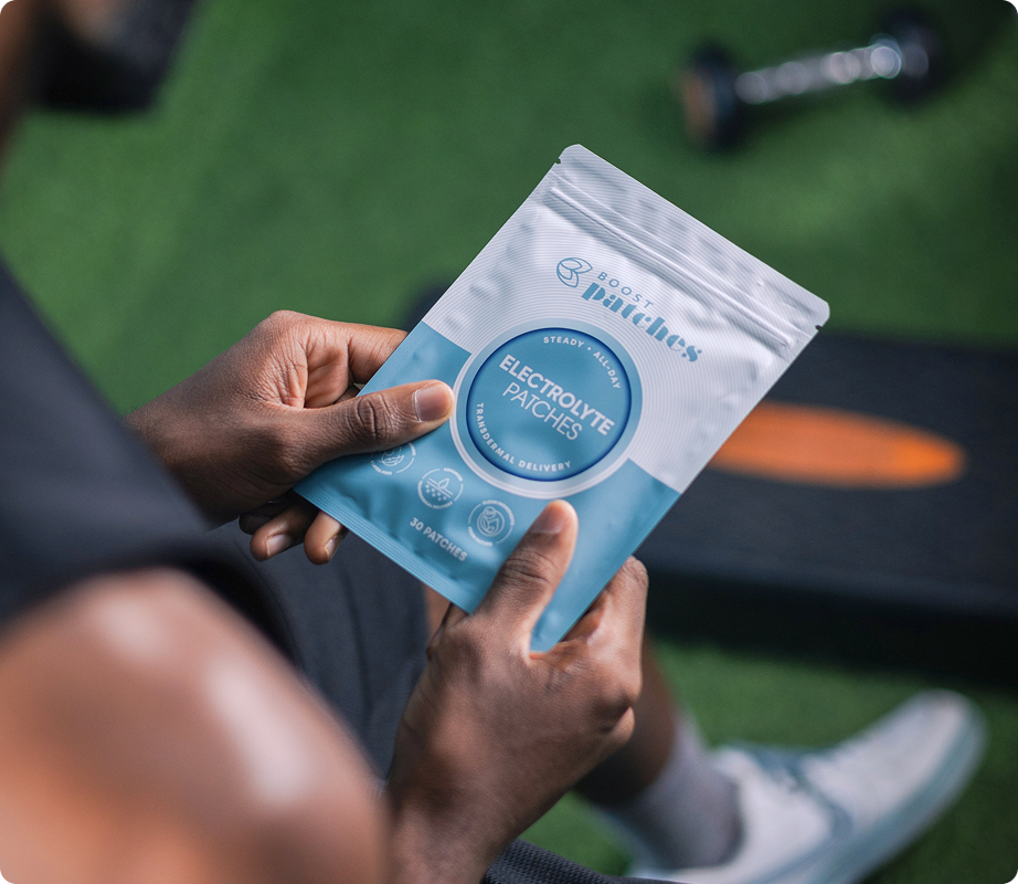 Person holding a Boost Patches wellness patch pouch outdoors as part of a modern daily wellness routine